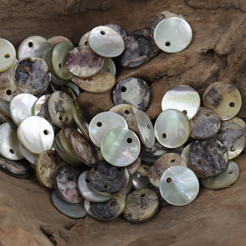 Assorted round mother-of-pearl shell buttons with single holes; natural pastel tones