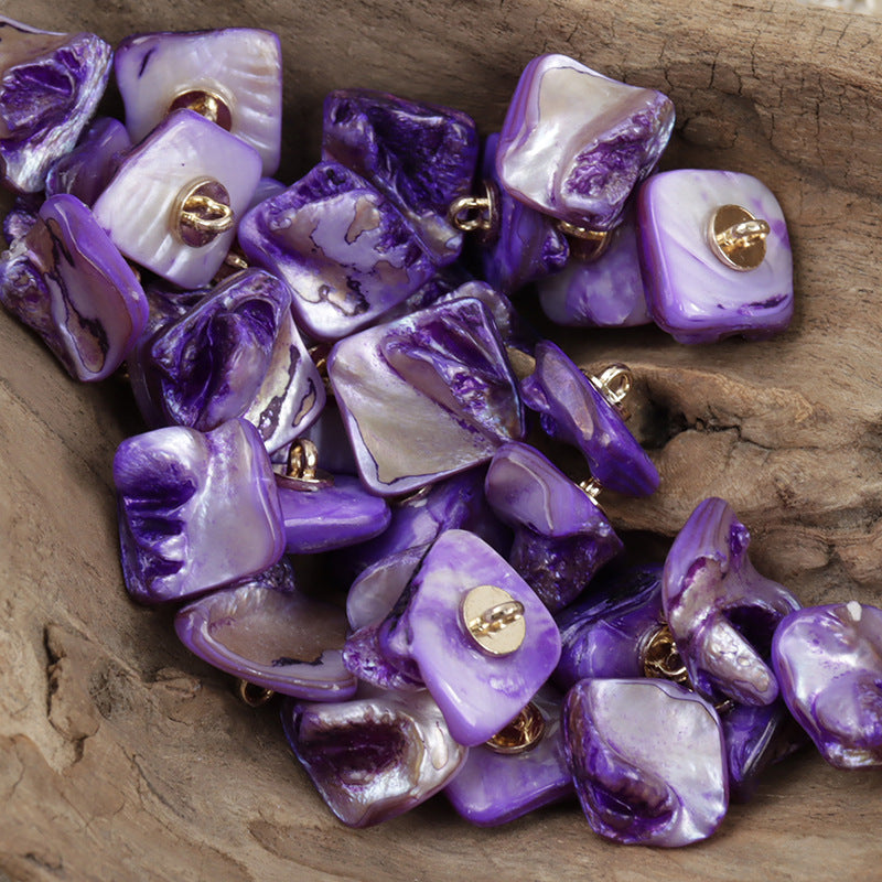 Purple shell shank buttons, square shape, with gold-toned metal loops