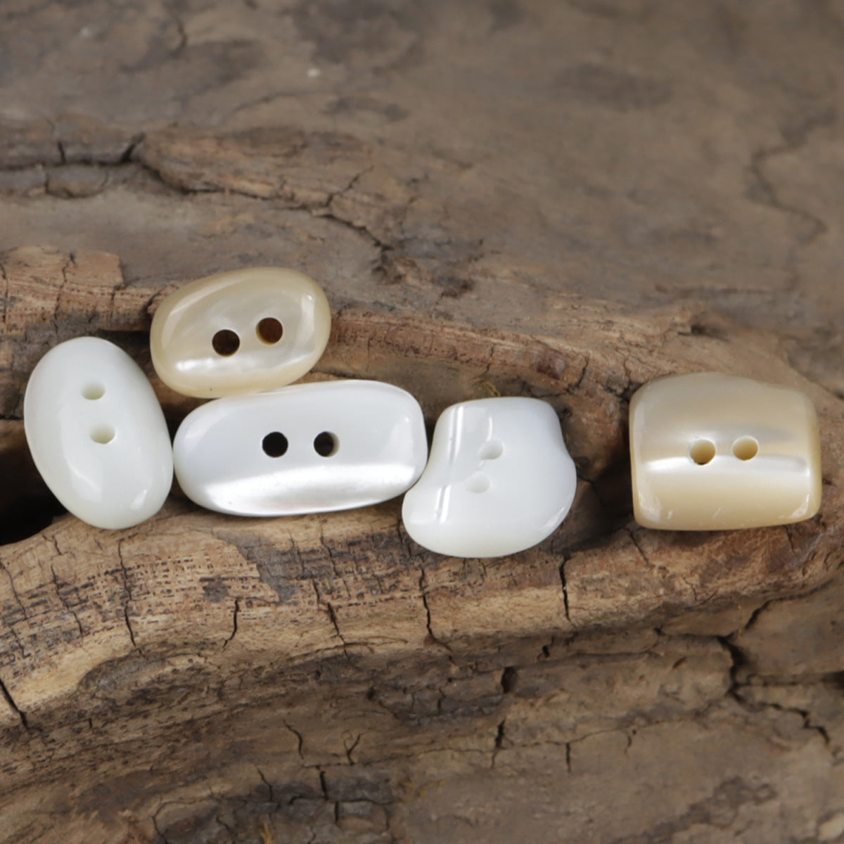 Irregular oval cream buttons for shirts with 2 holes, assorted shapes (10 pcs)