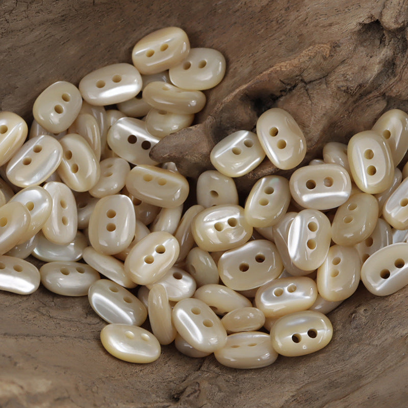 Irregular oval pale cream buttons with 2 holes, glossy shell buttons (10 pcs)