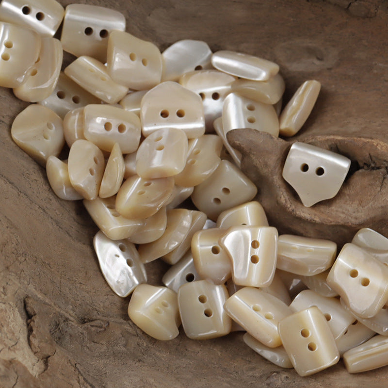 Irregular oval shell buttons, cream to light yellow, 2-hole face (10 pcs)