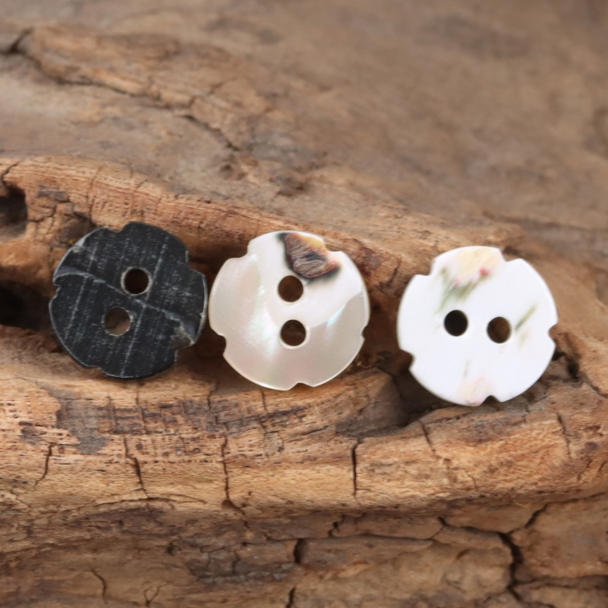 Petal-shaped 2-hole shell buttons, black, white, and pale floral