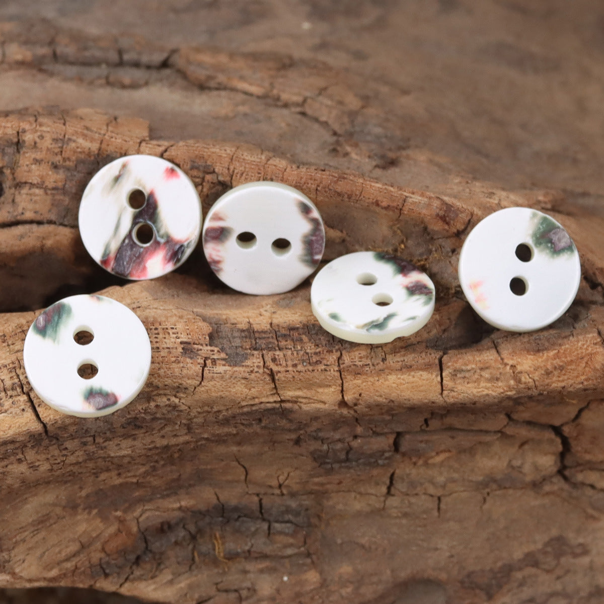 White natural shell buttons, round 2-hole, floral marbled accents on the face