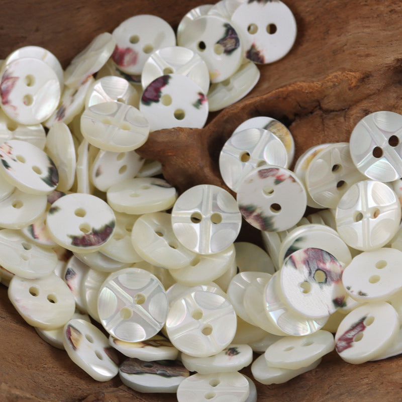 White natural shell buttons, round 2- and 3-hole faces with floral marbled pattern