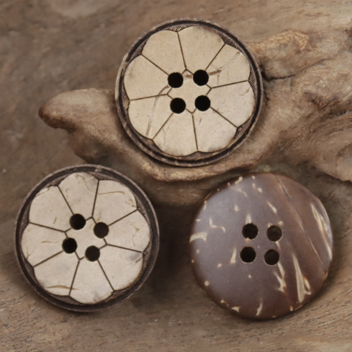 Set of natural coconut shell four-hole buttons with ethnic designs and dark edges