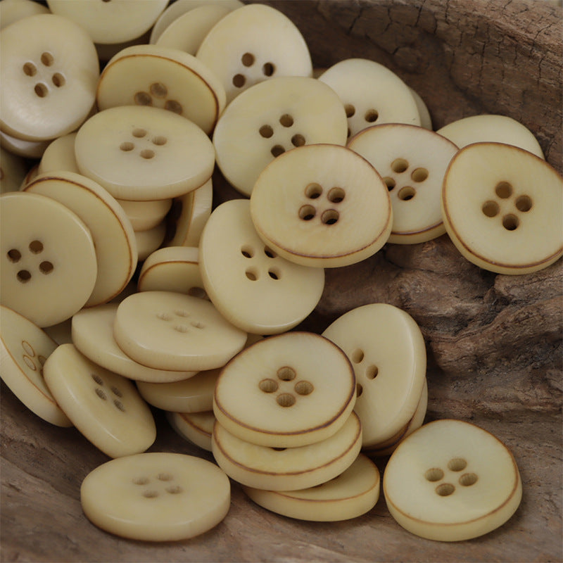 Mixed corozo buttons, irregular bowl shape, 4-hole; some stacked with darker rim rings