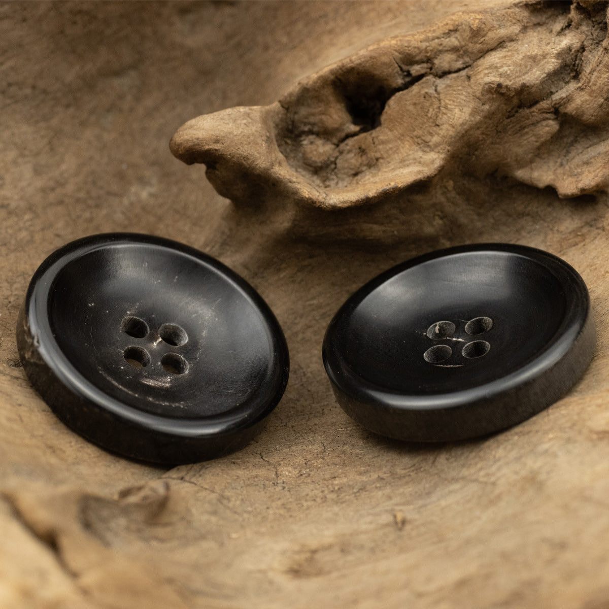 Set of black buffalo horn coat buttons, two round 4-hole fronts