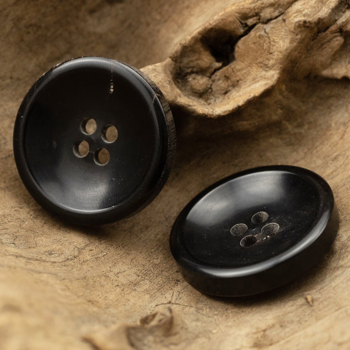 Black buffalo horn coat button pair, glossy round fronts with 4 holes