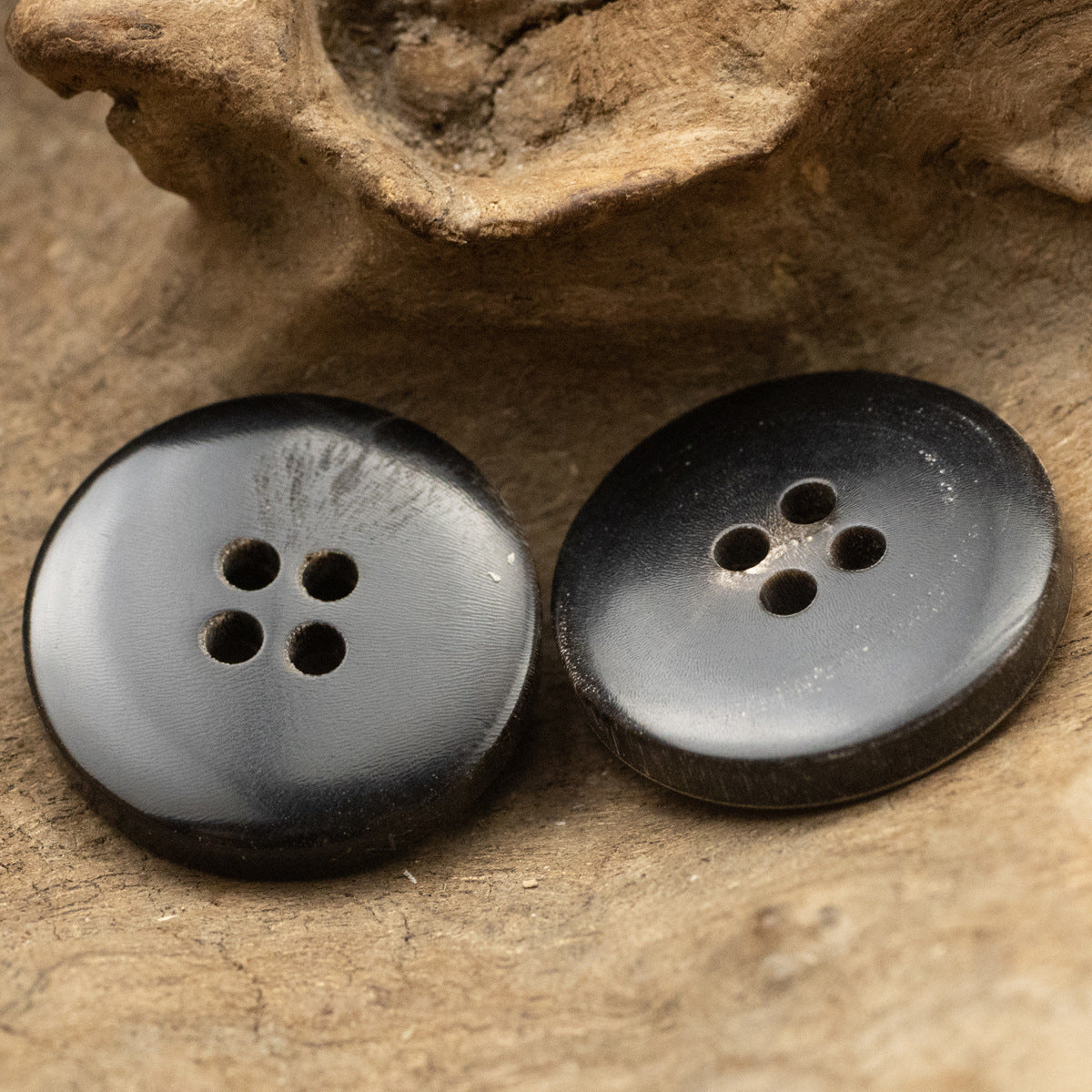 Black horn buttons with 4 holes, smoky gray finish and worn horn edge