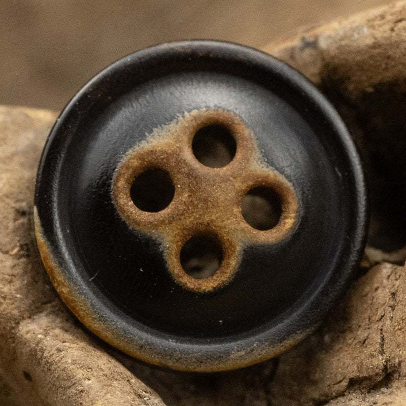 Black horn shirt button, 4-hole design with burnt-edge border