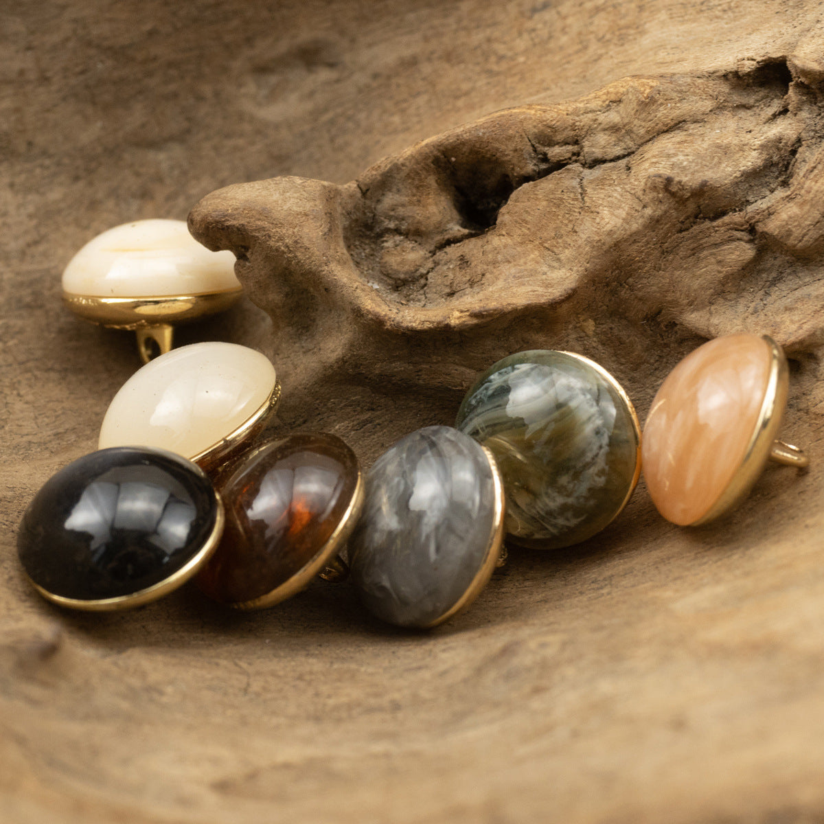Assorted round stone-look buttons with gold shanks: white, black, gray, green marble, peach