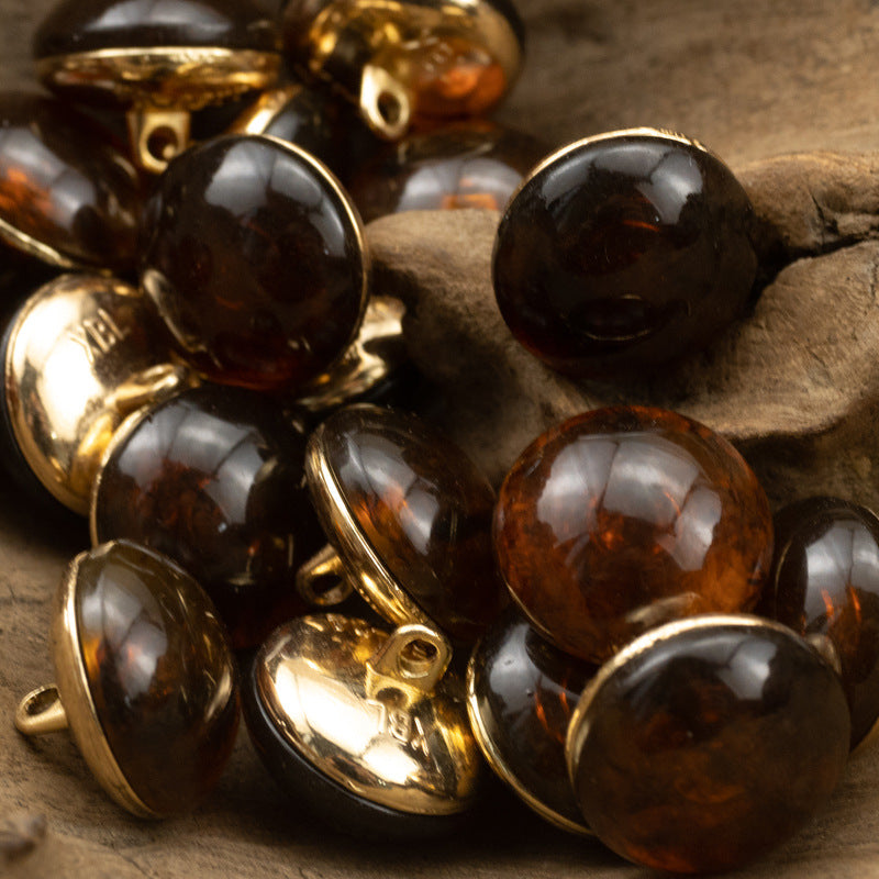 Dark brown and black round cheongsam buttons with gold metal shanks, glossy stone-look fronts