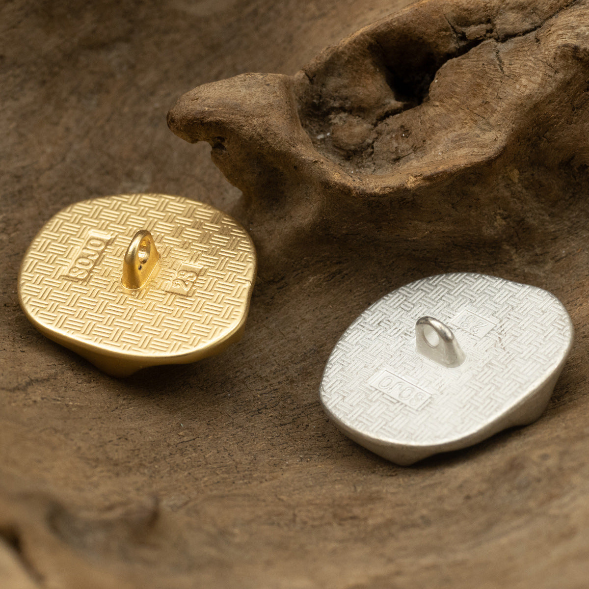 Geometric metal shank button set with gold and silver textured fronts and loop holes