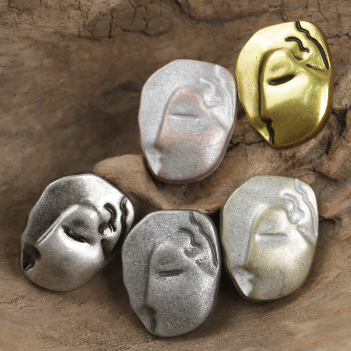 Face-motif buttons, silver-tone and gold-tone finishes, irregular metal shapes