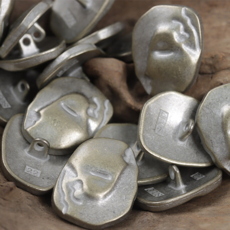 Silver-tone face buttons, metal shank backs visible on the irregular button fronts