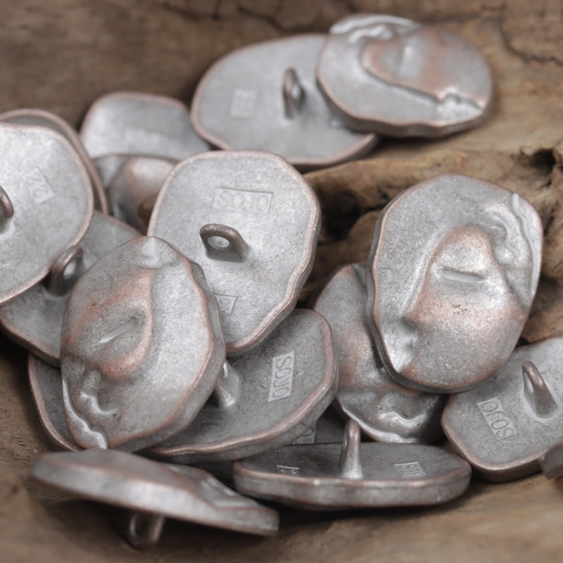 Silver-tone face-motif buttons with metal shanks, irregular oval shapes in a set