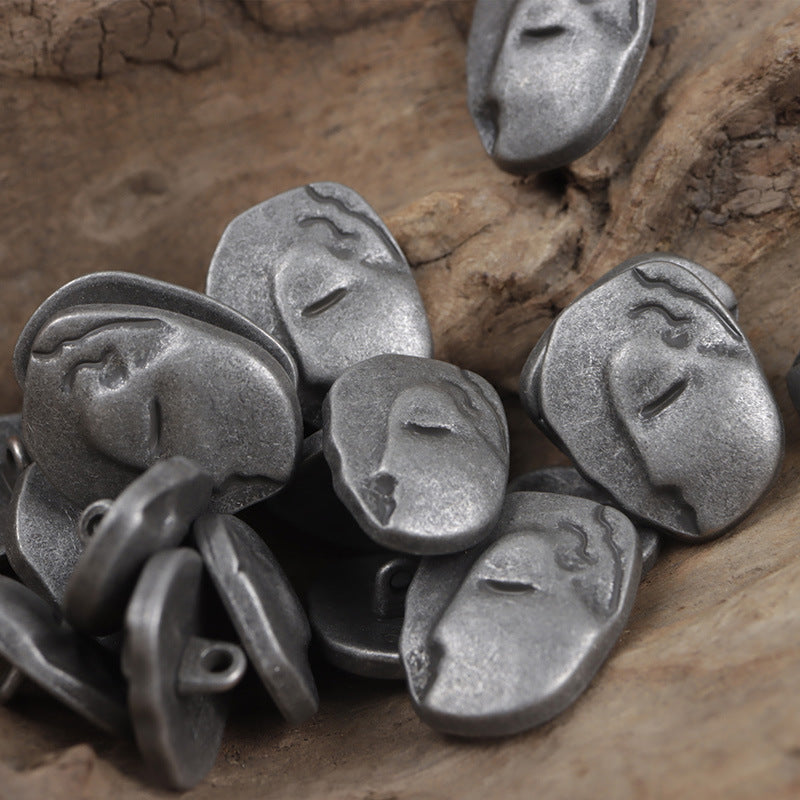 Silver-tone face buttons with metal shanks, irregular oval forms shown from the front