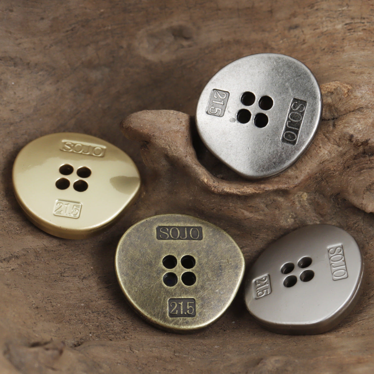 Four-hole metal triangle buttons in mixed finishes: light gold, antique bronze, white nickel