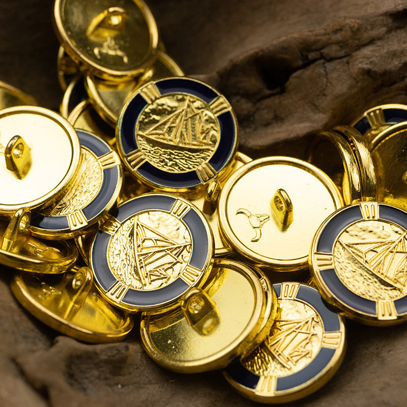 Metal shank buttons with gold sailboat engravings and dotted gold trim; close-up on multiple fronts