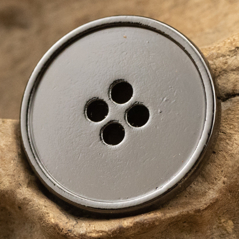 Round 4-hole metal button, matte silver-gray face with four dark holes