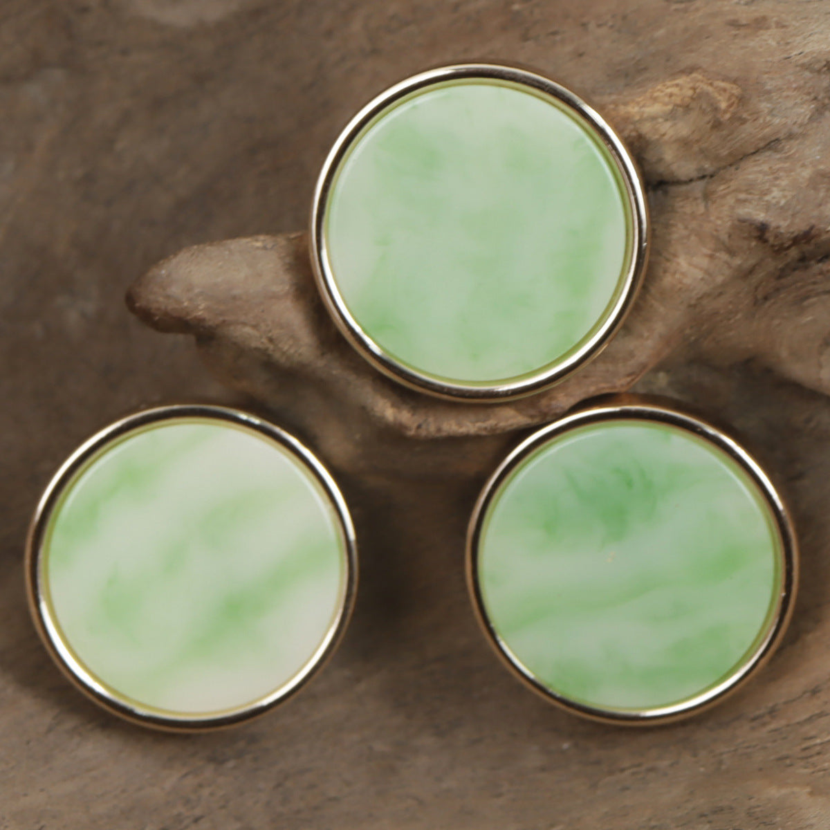 Three jade green resin buttons with gold-tone metal edging, round front faces