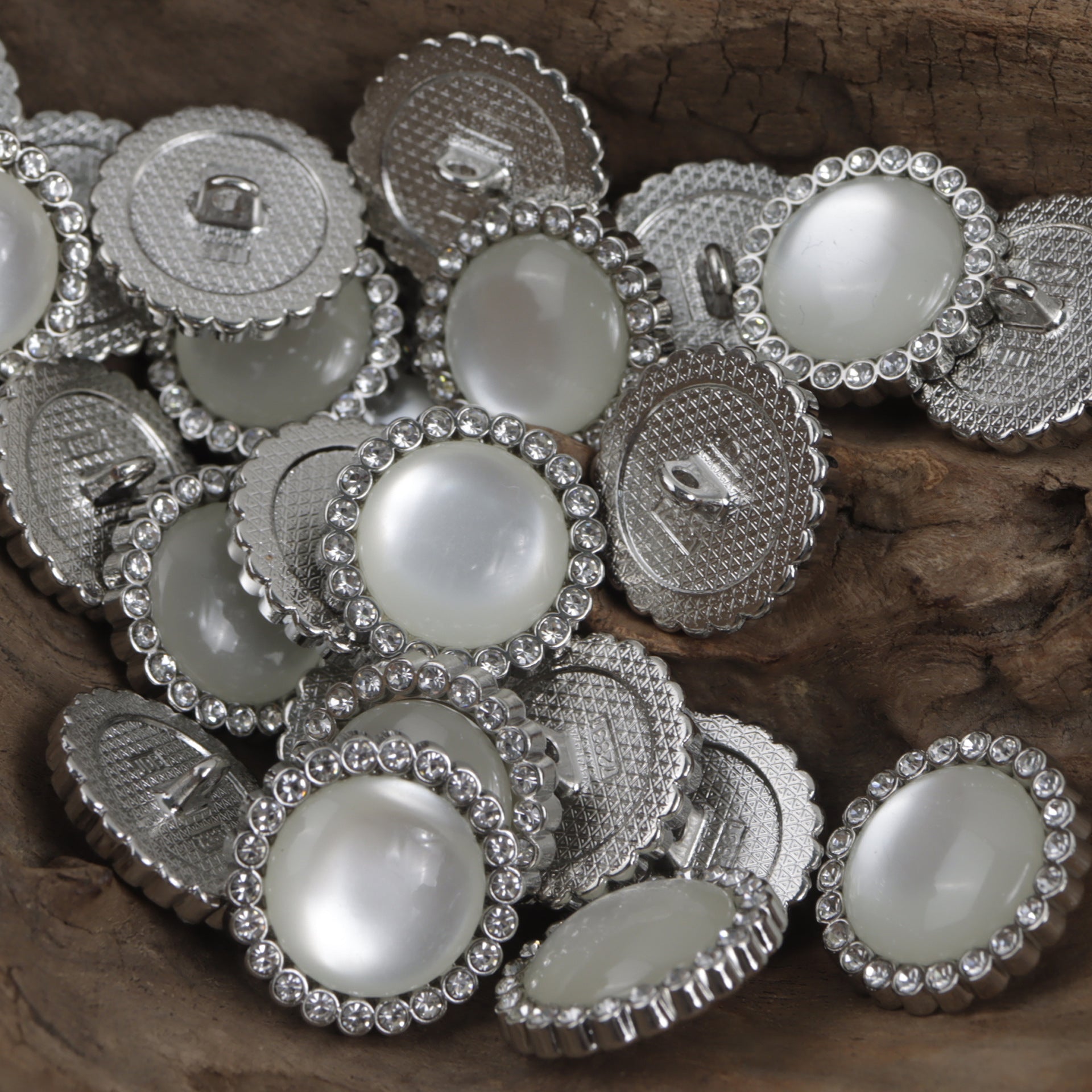 Set of silver metal buttons with white centers and crystal border, metal shanks