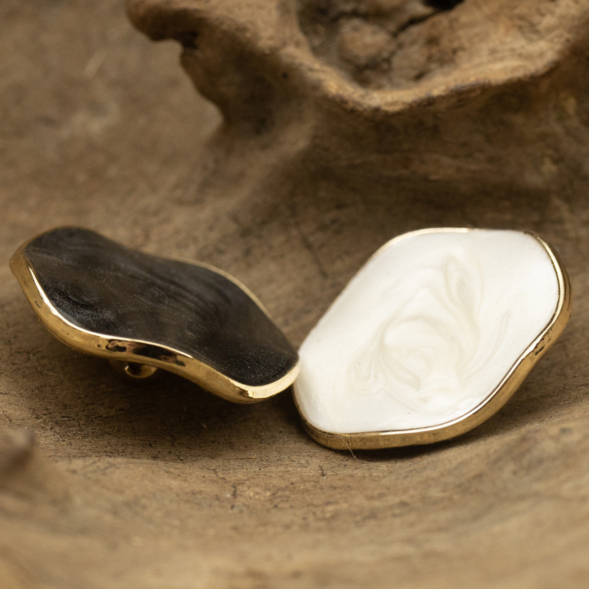 Curved pearl coat button, white face with gold edge and metal shank