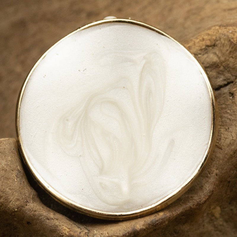 Curved irregular pearl coat button, white front with gold rim