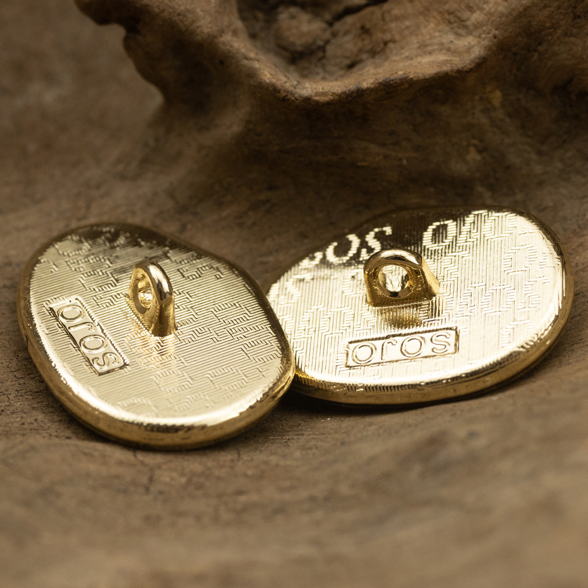 Button backs in white and black, gold-tone shanks with stamped markings.