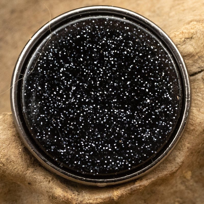 Round resin-faced metal button, black glitter pearl-lustre top with silver-toned edge