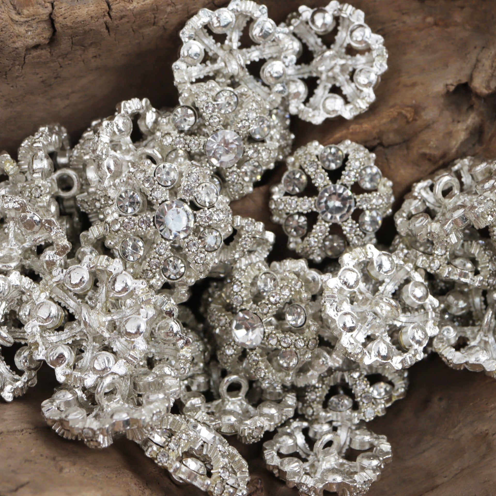 Silver-tone irregular snowflake rhinestone inlaid hollow metal buttons, close-up