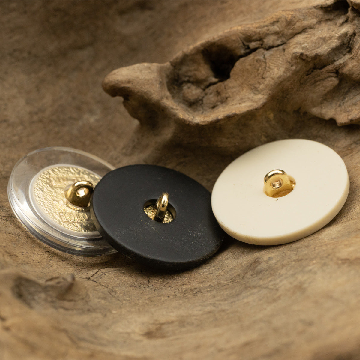 Back view of retro portrait resin buttons: beige, black, transparent with gold metal shanks