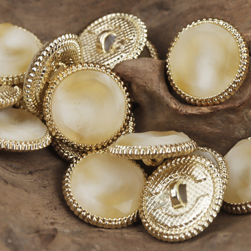 Beige resin buttons with gold beaded border and metal loop shank