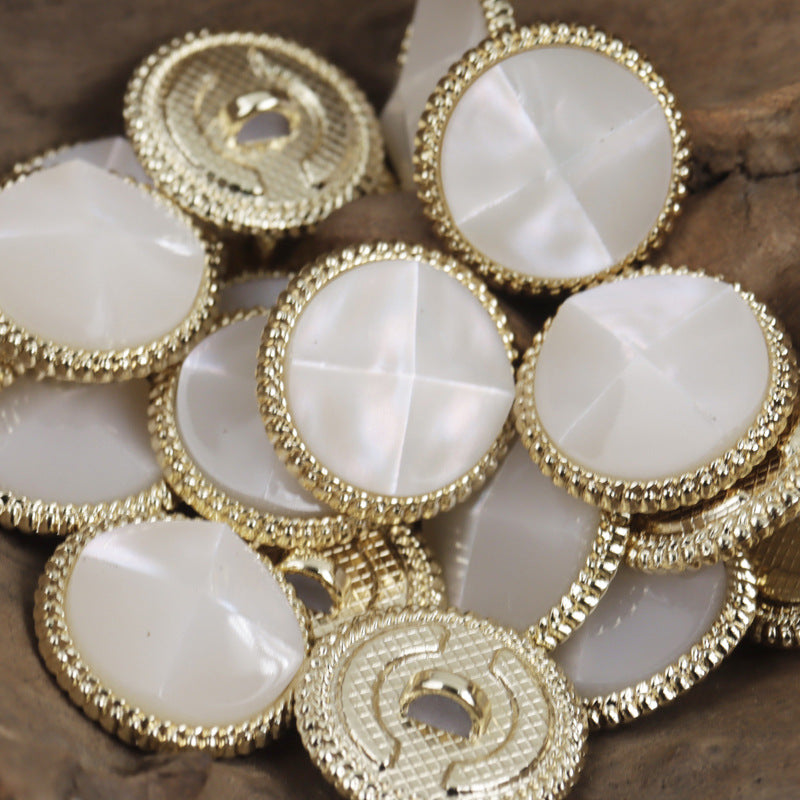 White resin tortoise-shell buttons, gold metal bases, glossy faceted surface