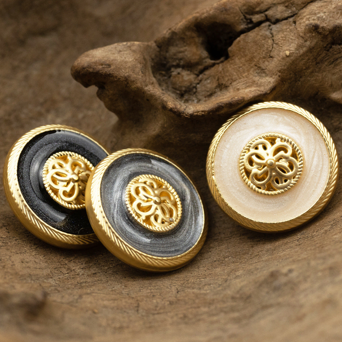 Pearl-glaze shank buttons: white and dark gray/black, ornate gold filigree centers