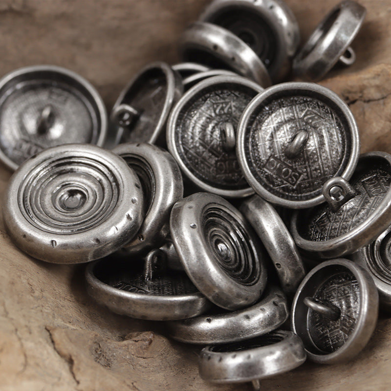 Metal shank buttons with spiral fronts and stamped backs in silver tones