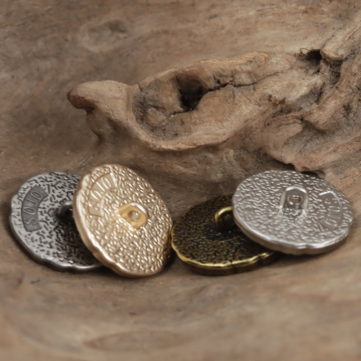 Embossed rose metal shank button backs in silver, gold, and dark tones