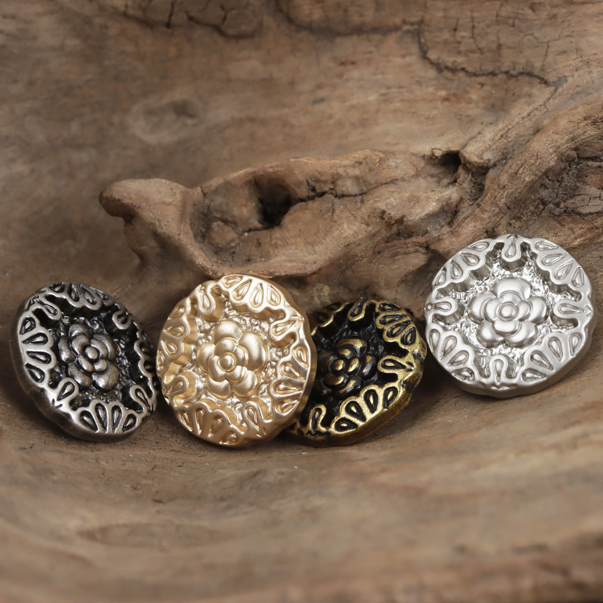 Assorted embossed rose metal shank buttons in gold, bronze, silver, and dark finishes