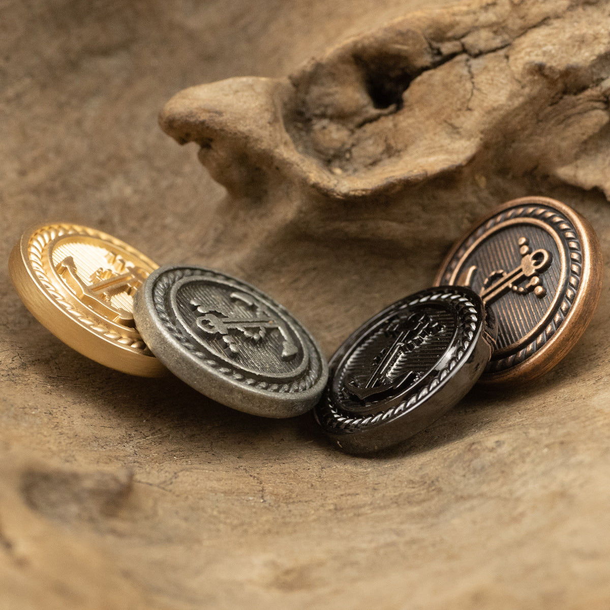 Set of nautical anchor metal buttons in gold, silver, red bronze, and black