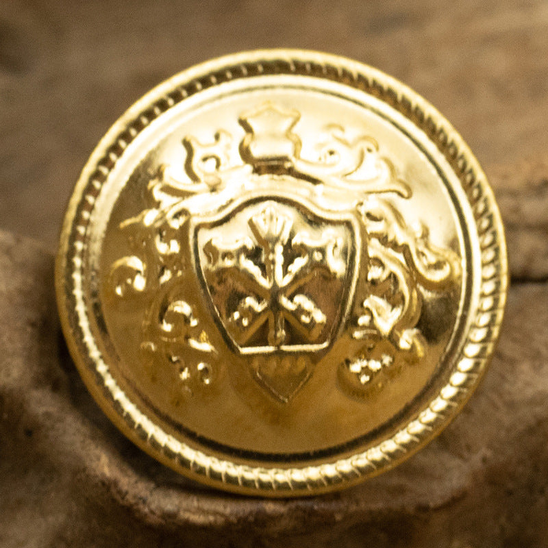 Gold crown crest metal shank button with ornate shield and scalloped edge