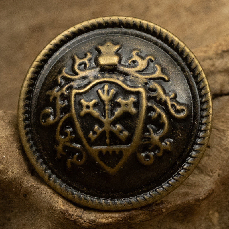 Bronze crown crest metal shank button with ornate shield and scalloped edge