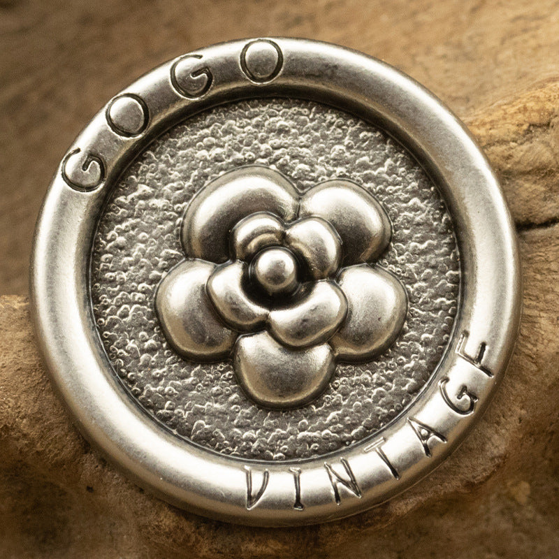 Antique silver metal shank button with rose relief pattern and engraved rim