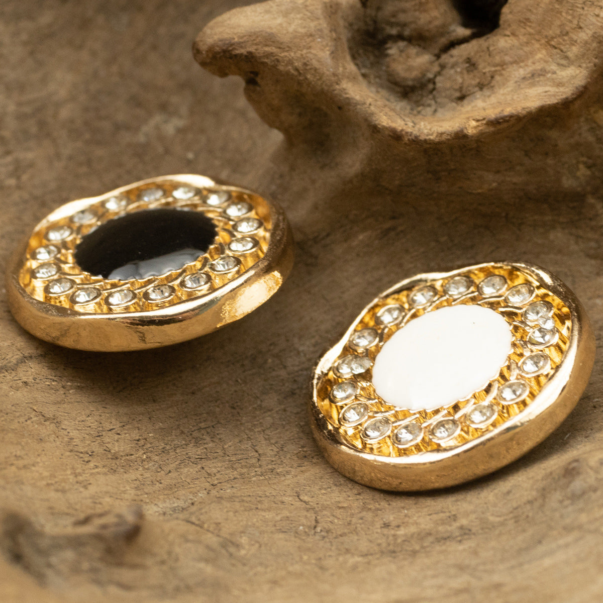 Gold rhinestone-dotted button pair with black and white centers