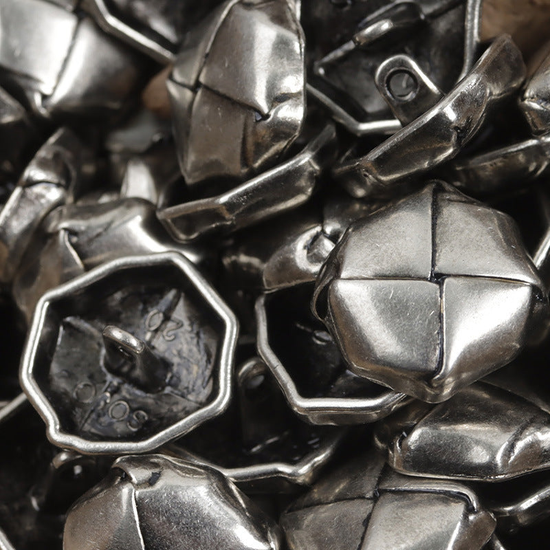 Beret-shaped silver lacquered woven metal buttons with loop shank undersides, close-up