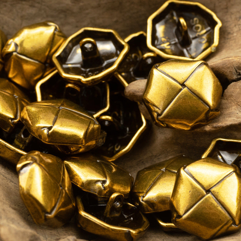 Beret-shaped gold and dark gold tone lacquered metal buttons with loop shank backs