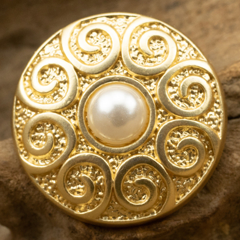 25mm gold-tone pearl metal button with ornate circular scrolls around center pearl