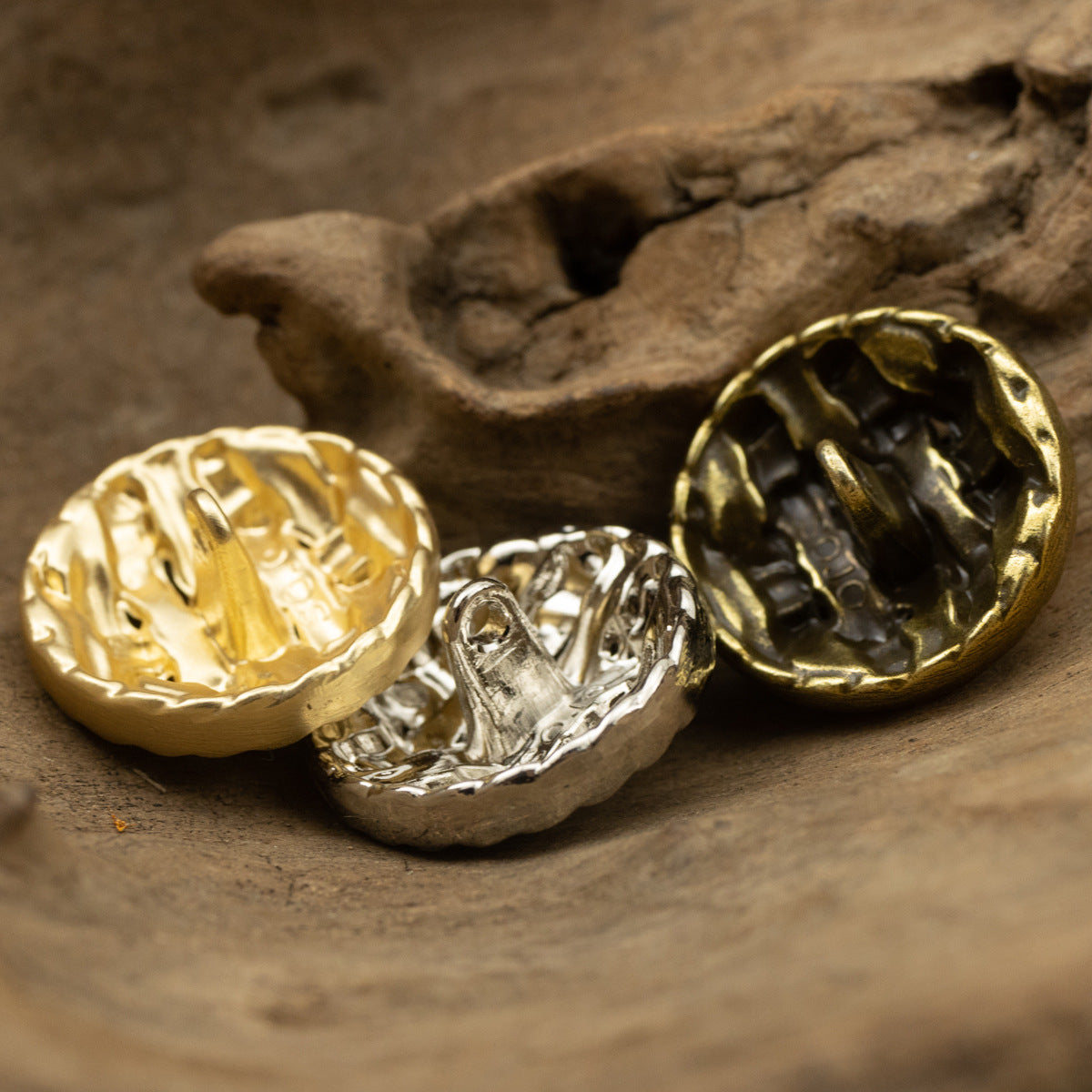 Gold, silver, and gold-tone twisted braided buttons with metal shanks
