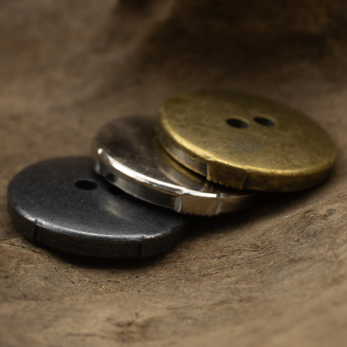 Cat’s eye metal buttons in black nickel and bronze, side view, 2-hole design