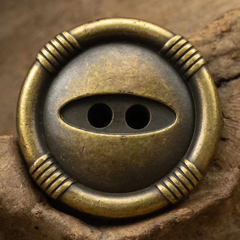 Bronze cat’s eye metal button with ridged edge and 2-hole shank