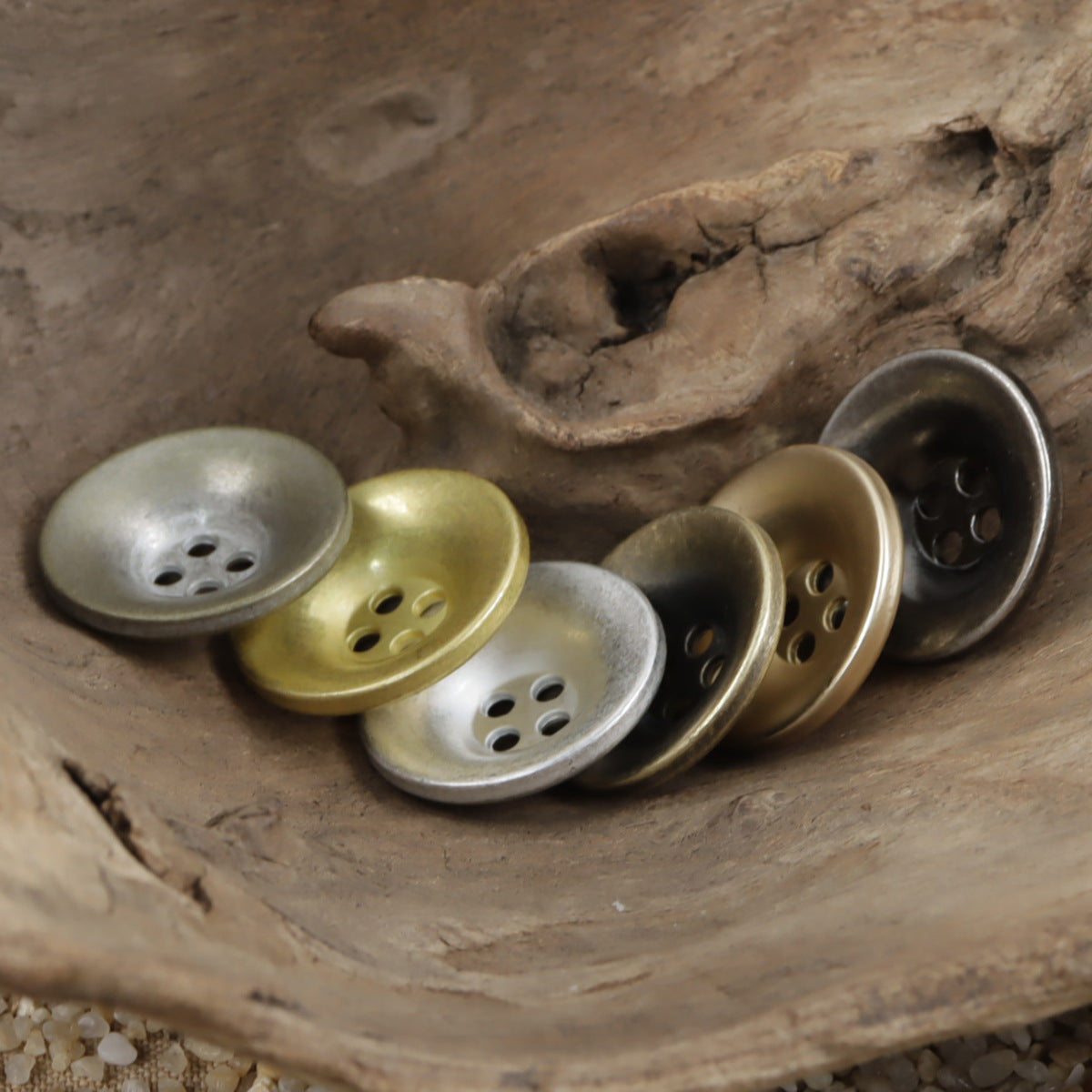 Metal overcoat buttons set with bronze and silver tones, round bowl shape, 4 holes